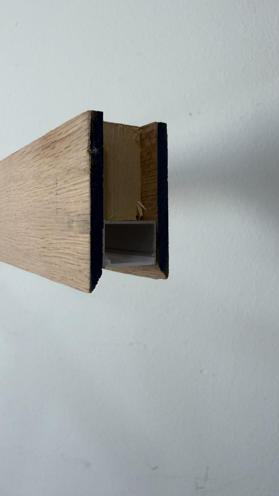 Cross-section detail of the oak and aluminum channel